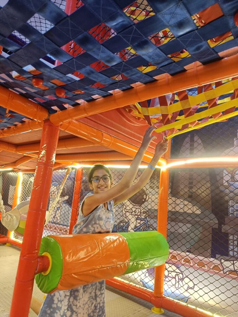 Child playing in the indoor play structure at Unplug Kids Jind